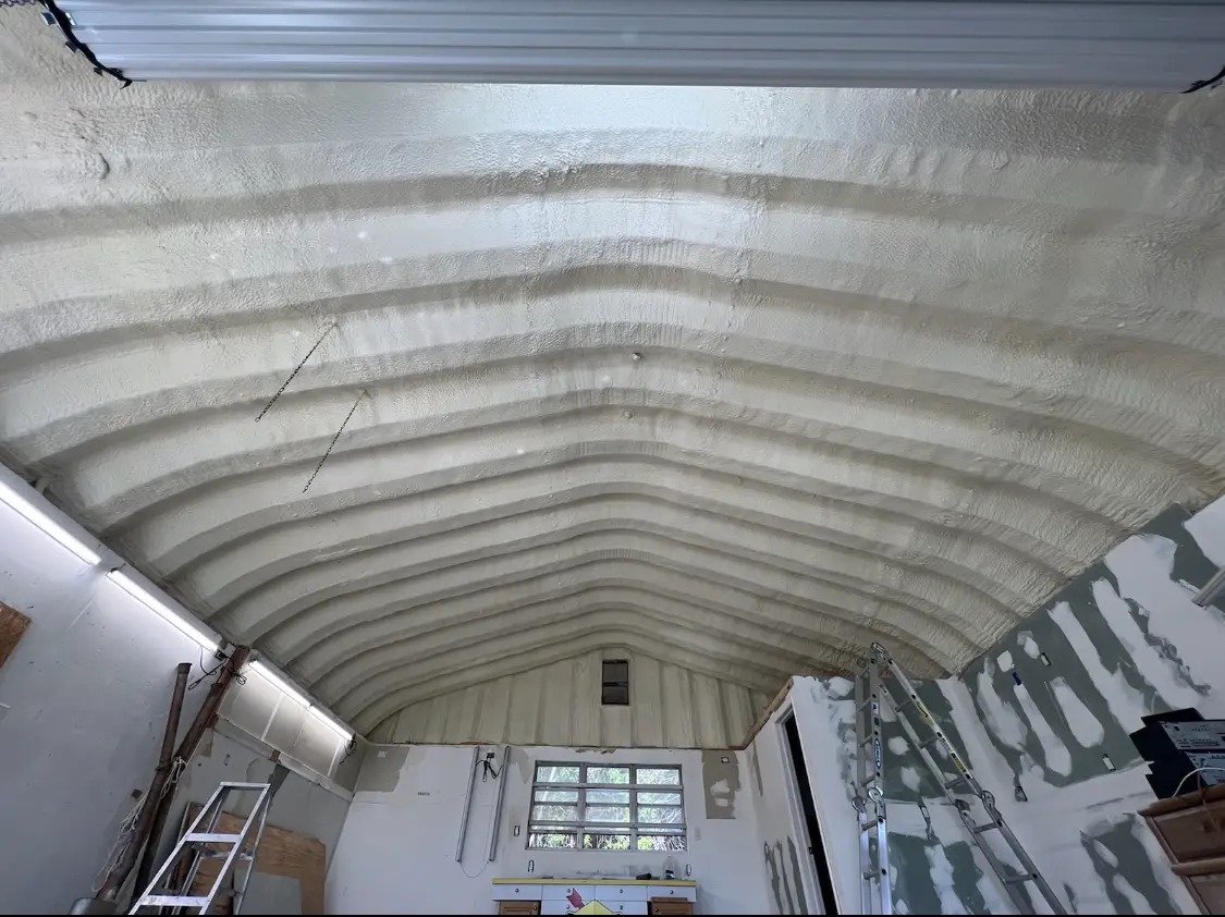 Spray polyurethane foam applied to the underside of a metal roof deck in Farmersville